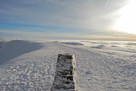 Trig point on Helvellyn with temperature inversion behind